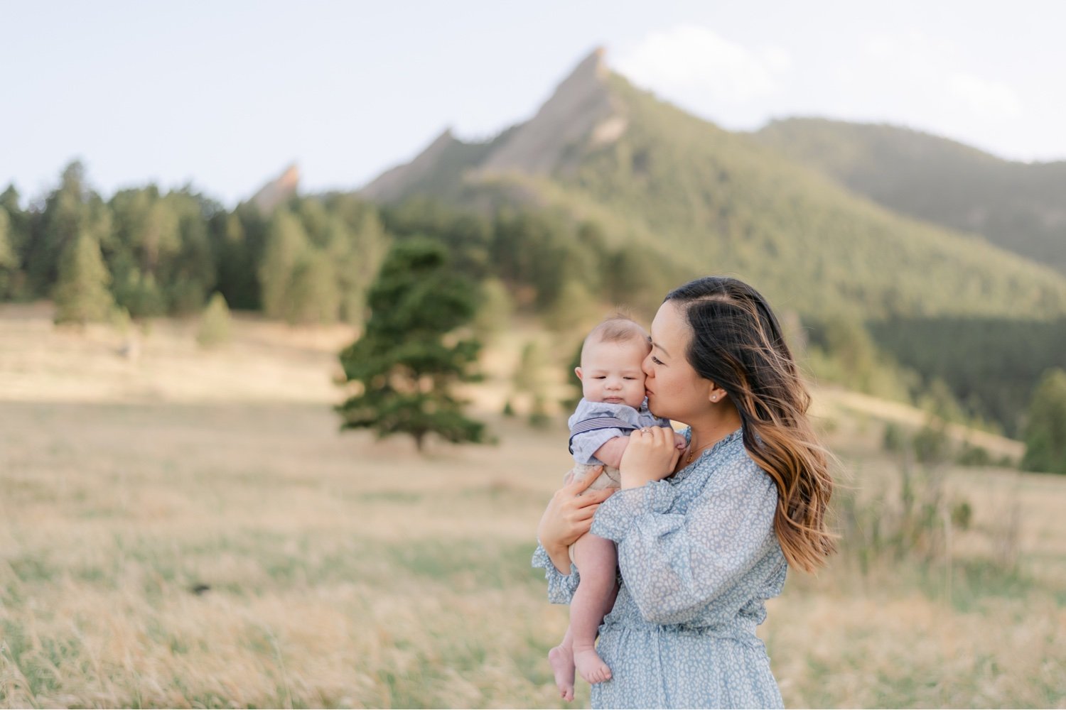 Mom kissing her son for a photo in Chautauqua Park locating in Boulder Colorado