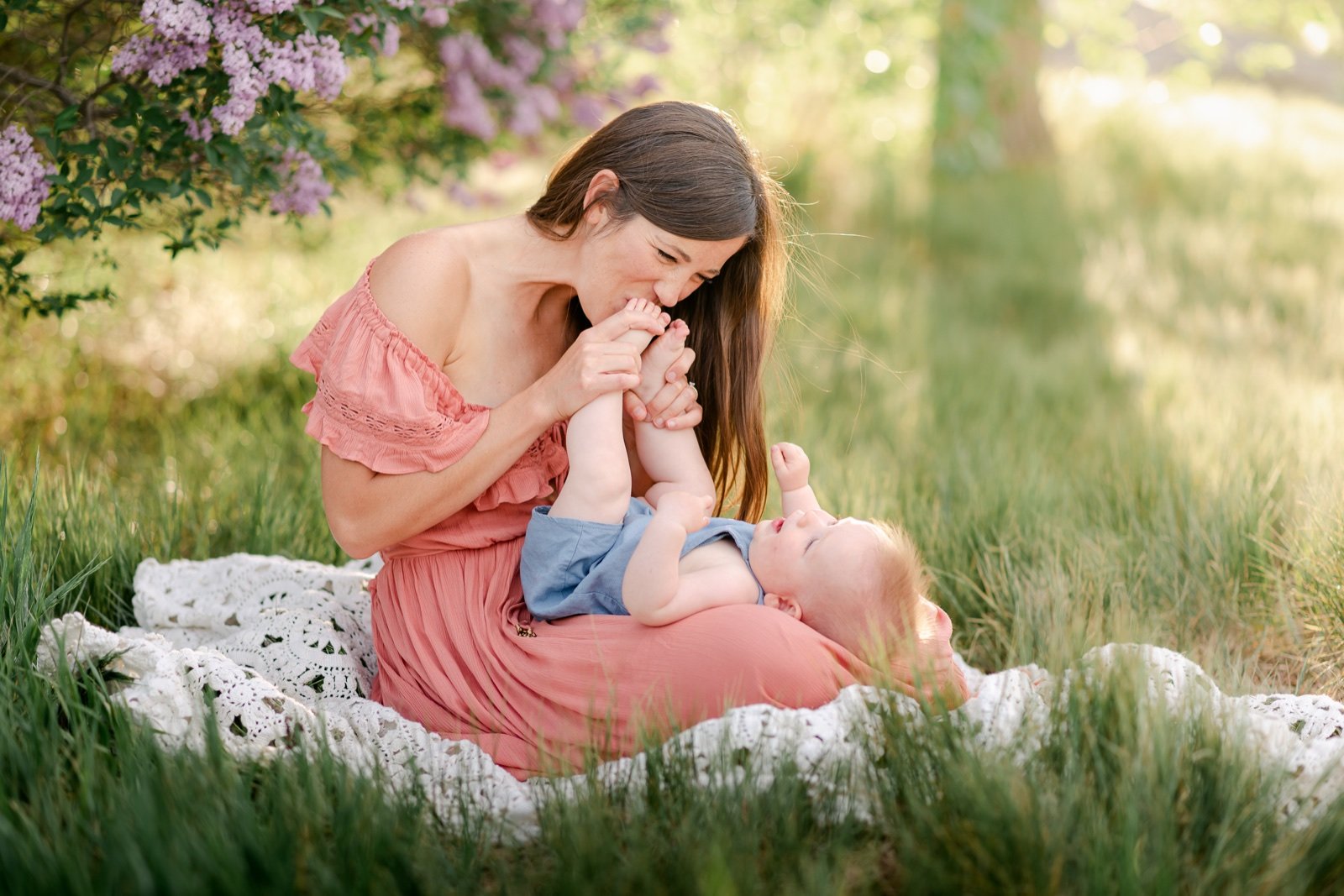 Mother kissing her son's toes during a photo session in Erie Colorado