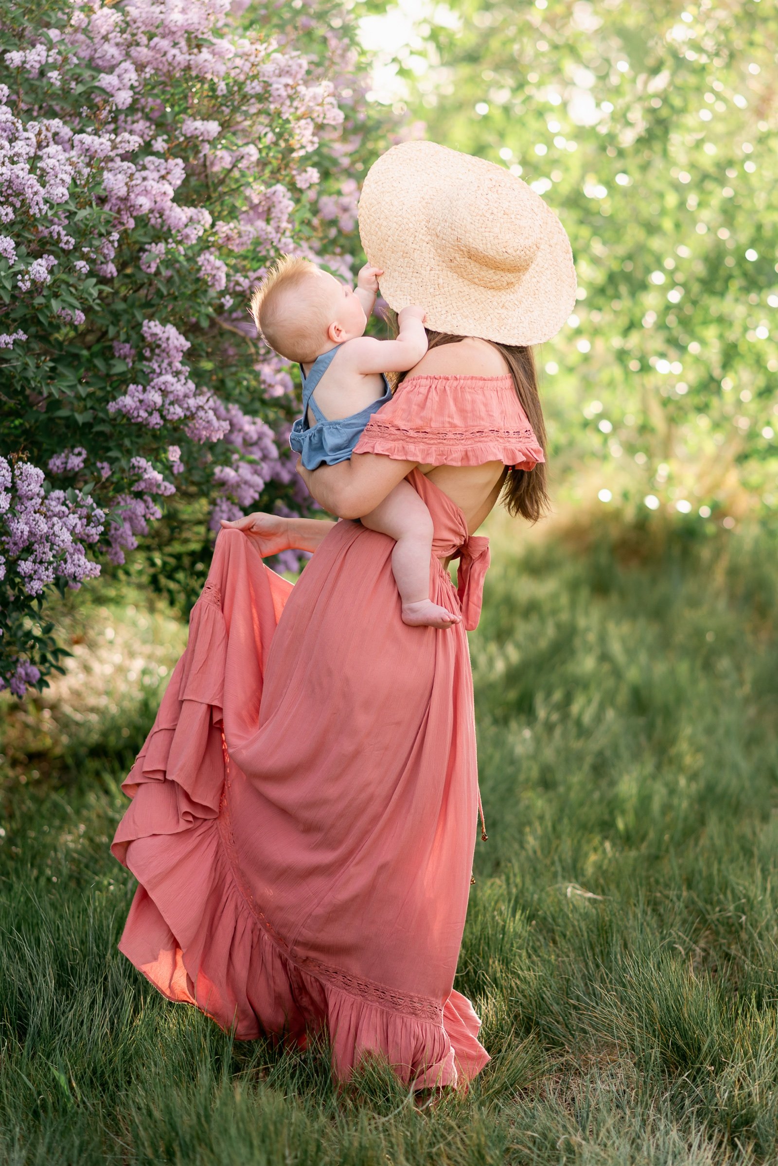 Son playing with mom's hat during a spring photoshoot near Boulder Colorado