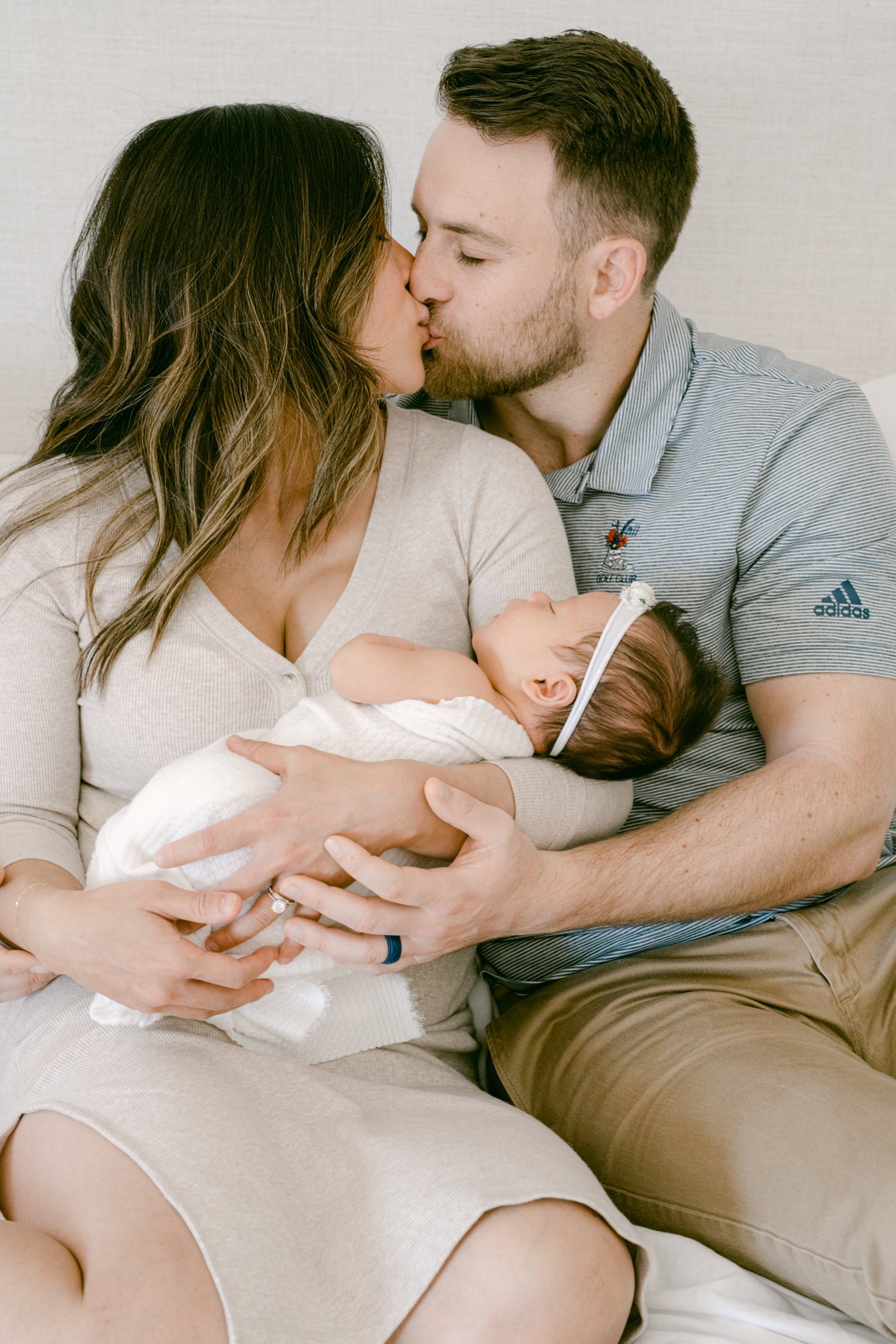 Young Colorado family sharing a tender moment during a newborn session