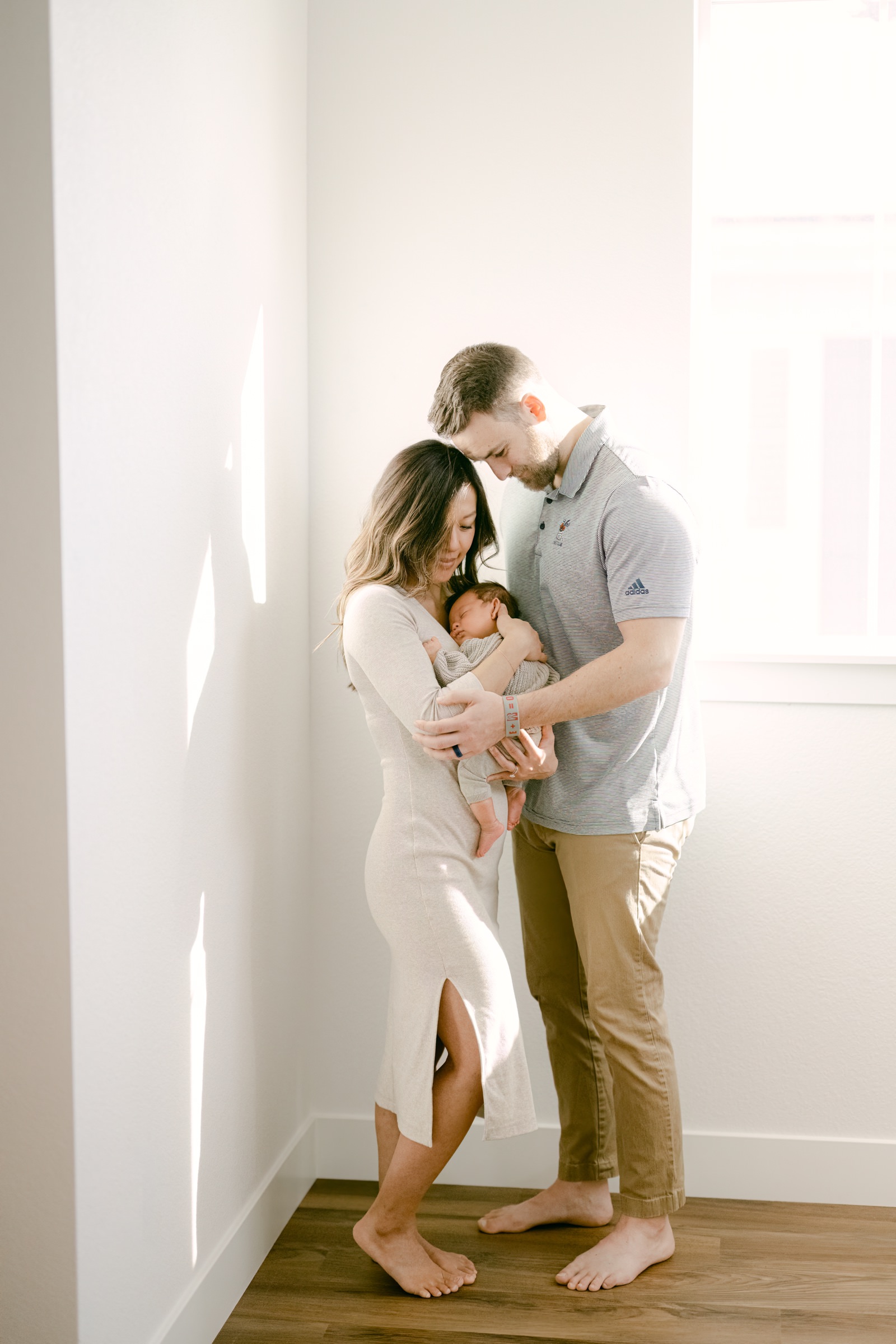 Boulder Photographer taking an artistic photo of a young family during a newborn session