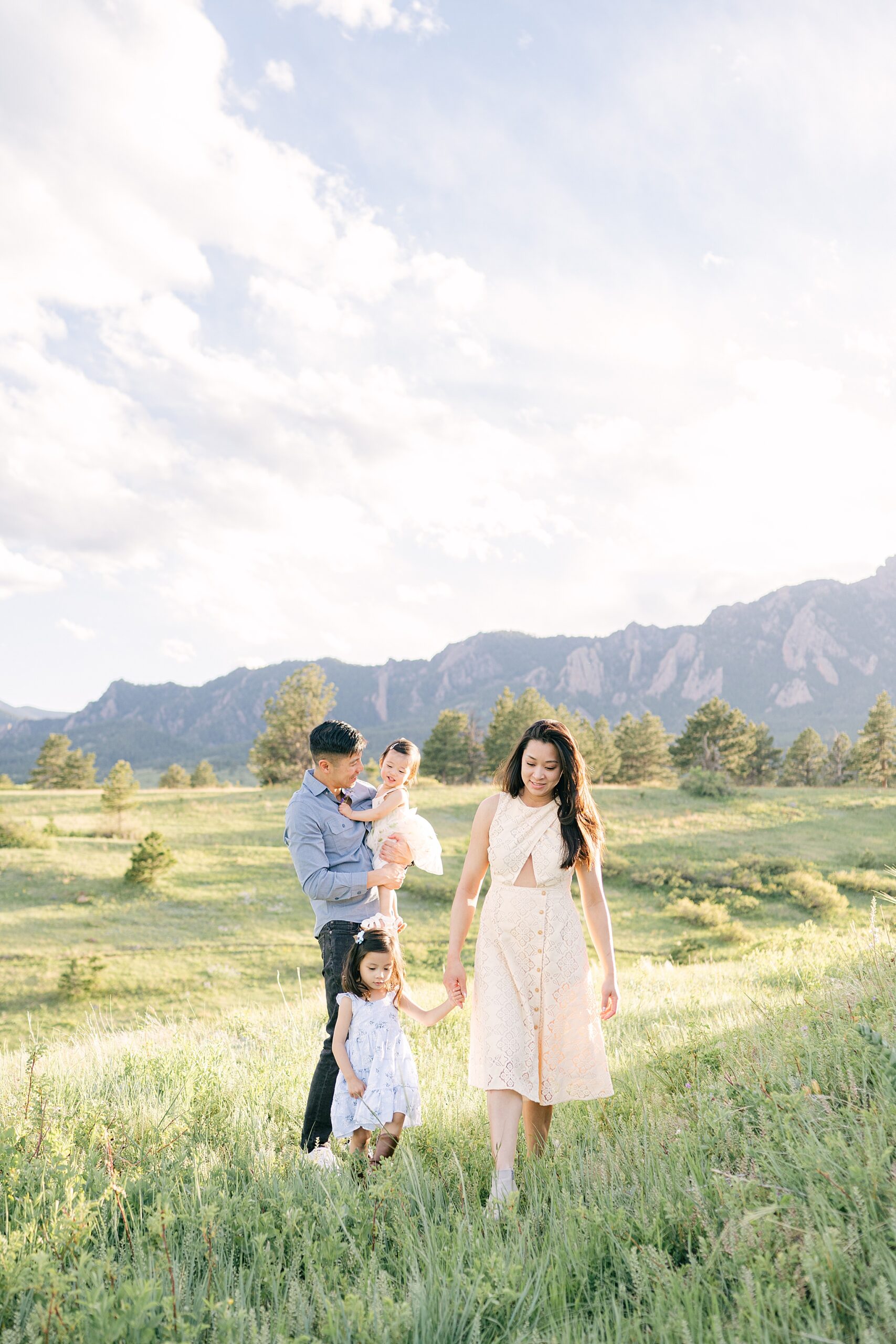 A young Colorado family of four in Boulder, CO with the mountains in the background