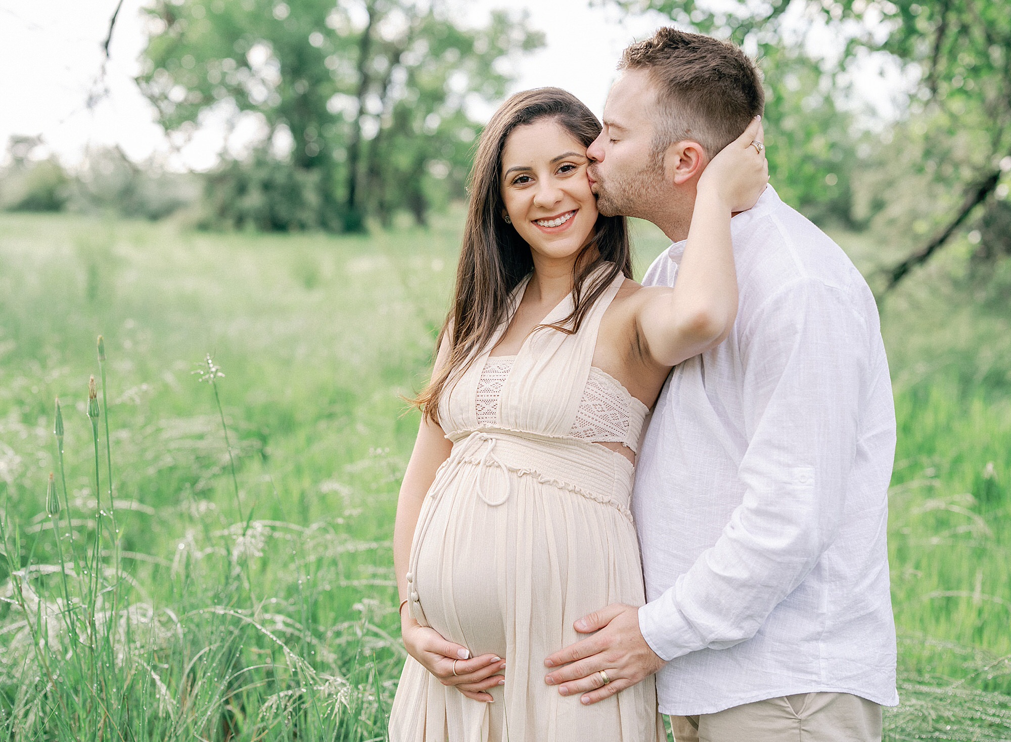A man kissing his pregnant wife during a Colorado maternity photoshoot taken by Olive and Aster in Boulder