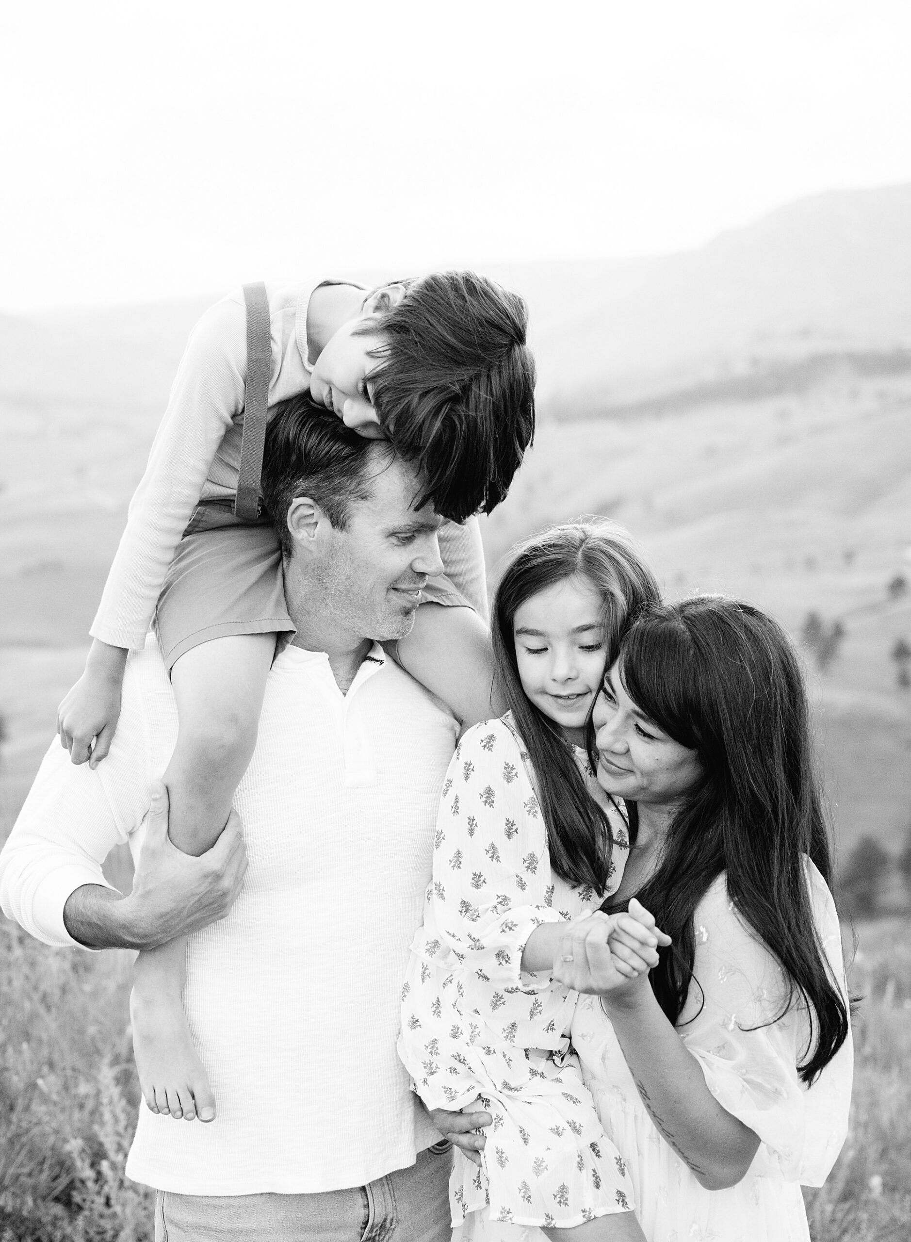 A joyful family laughing during a sunset photo session with a Denver family photographer